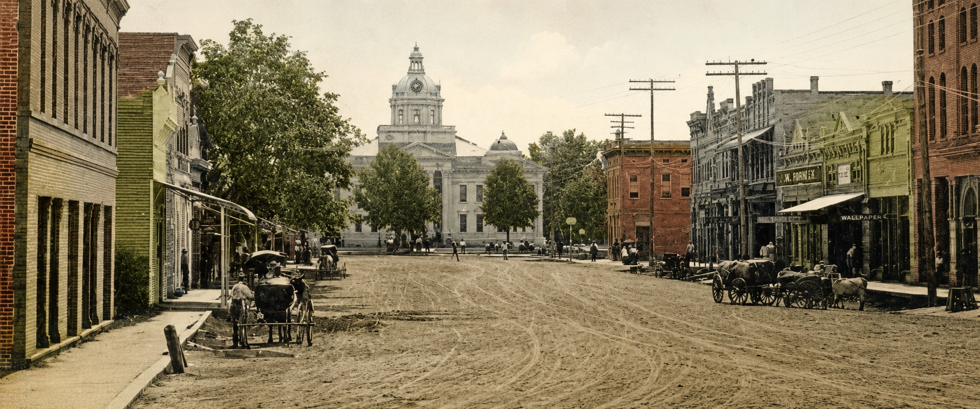 Main Street, Columbia, in the early 1900s — storefronts and awnings along the brick street