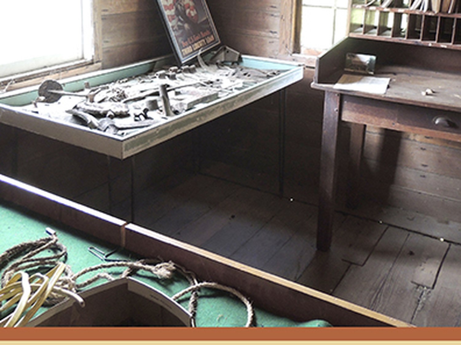 A display case and writing desk marking the site of the territorial post office